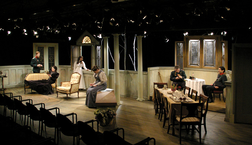 full stage look with lights focusing attention on living room-Theatre Fairfield's THREE SISTERS