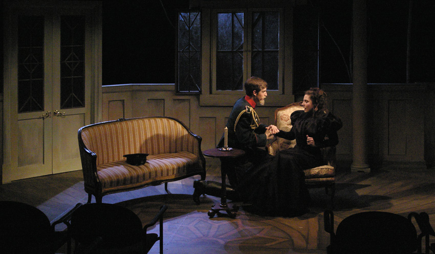 Vershinin and Masha in puddle of candlelight--Theatre Fairfield's THREE SISTERS