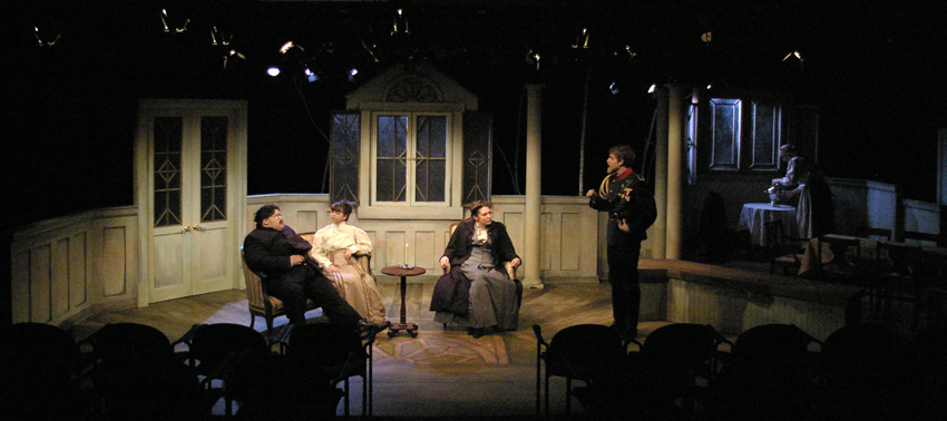 light in living room while servant clears table in moonlight--Theatre Fairfield's THREE SISTERS