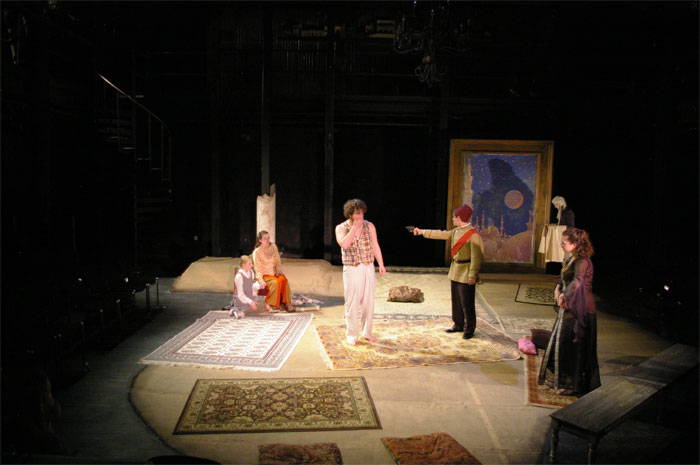 Shahryar threatens Scheherezade at gunpoint in tableau of Madman with Perfect Love-Theatre Fairfield's ARABIAN NIGHTS